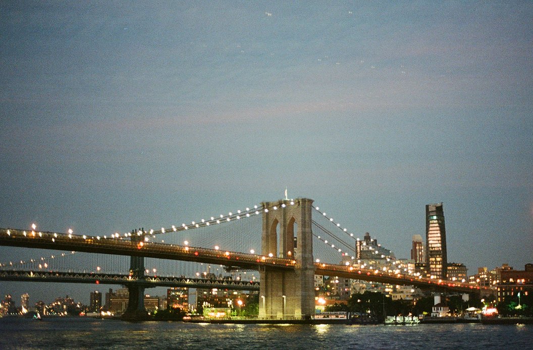 Brooklyn Bridge at night, viewed from the seaport in Manhattan.